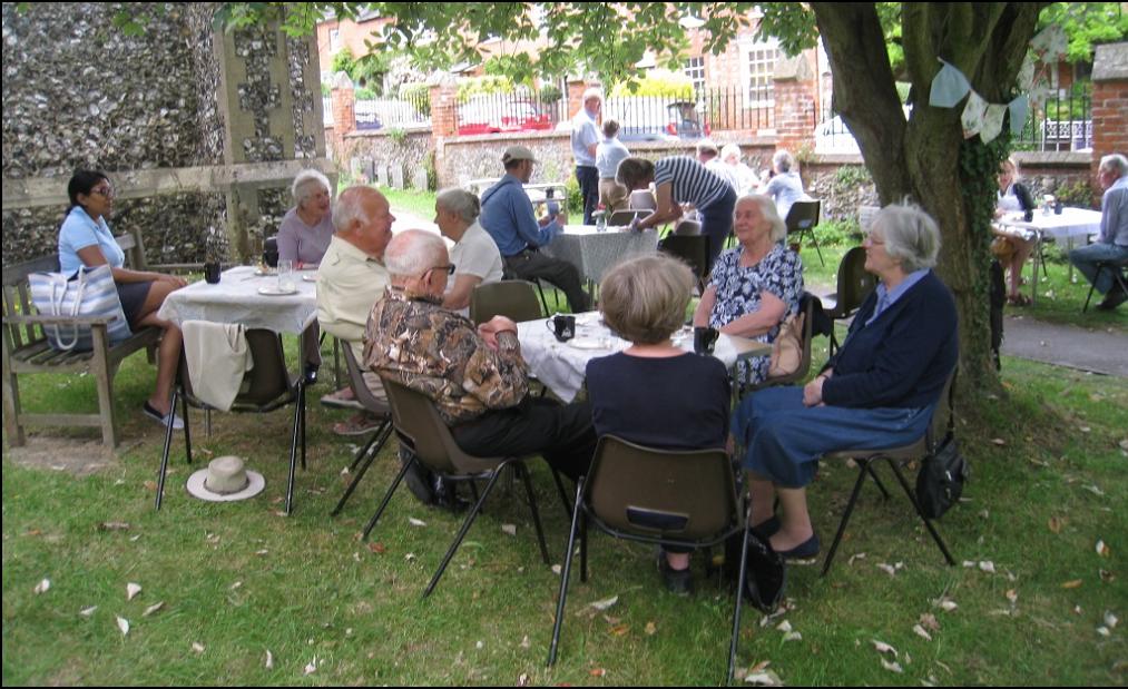 Satisfied customers enjoying their cream teas in the shade of the trees