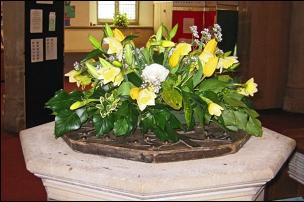 Easter flower display on the font